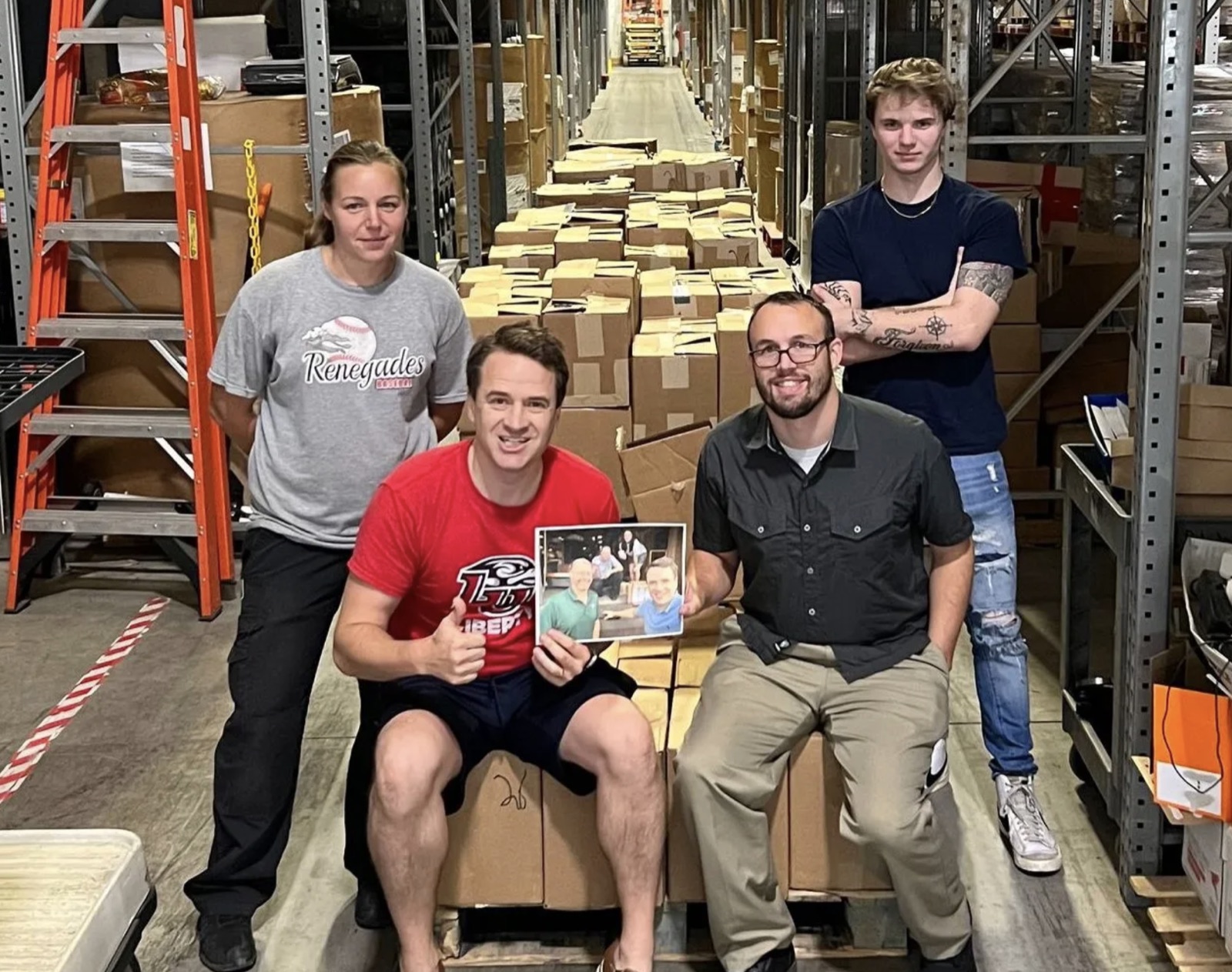 The ShareTheTruthNOW team at the warehouse with a huge card shipment